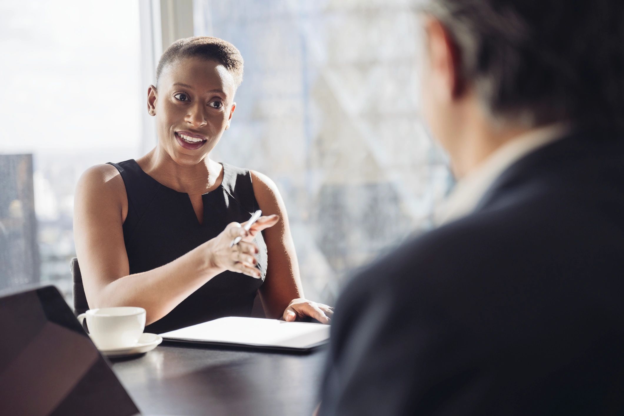 Accountant speaking with a client in a meeting room