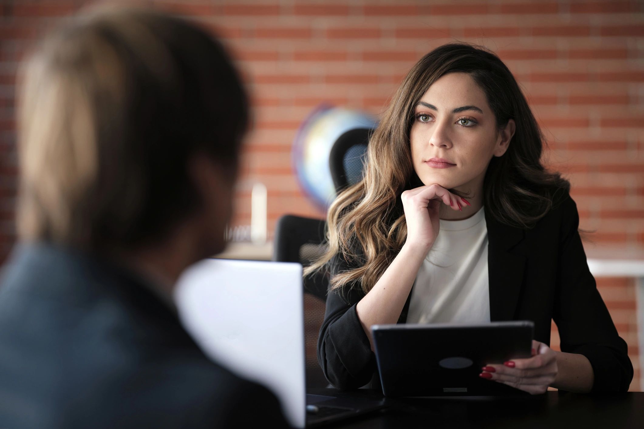 Advisor speaking with a client in a meeting room about next steps