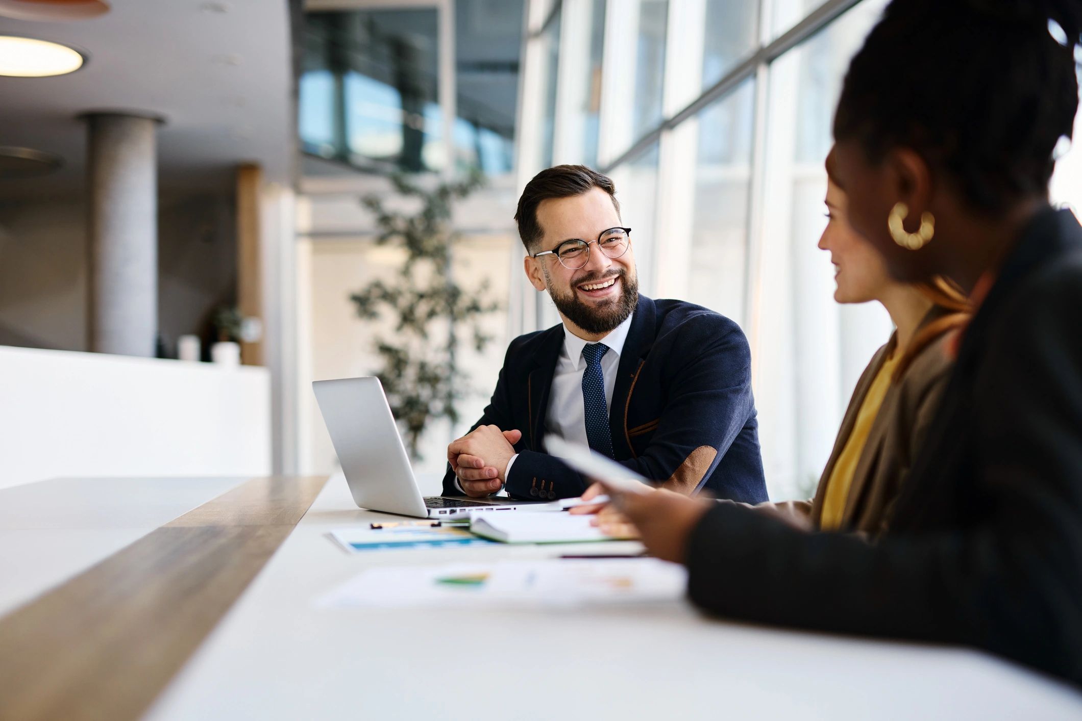 Professionals discussing financial strategy in a modern office meeting